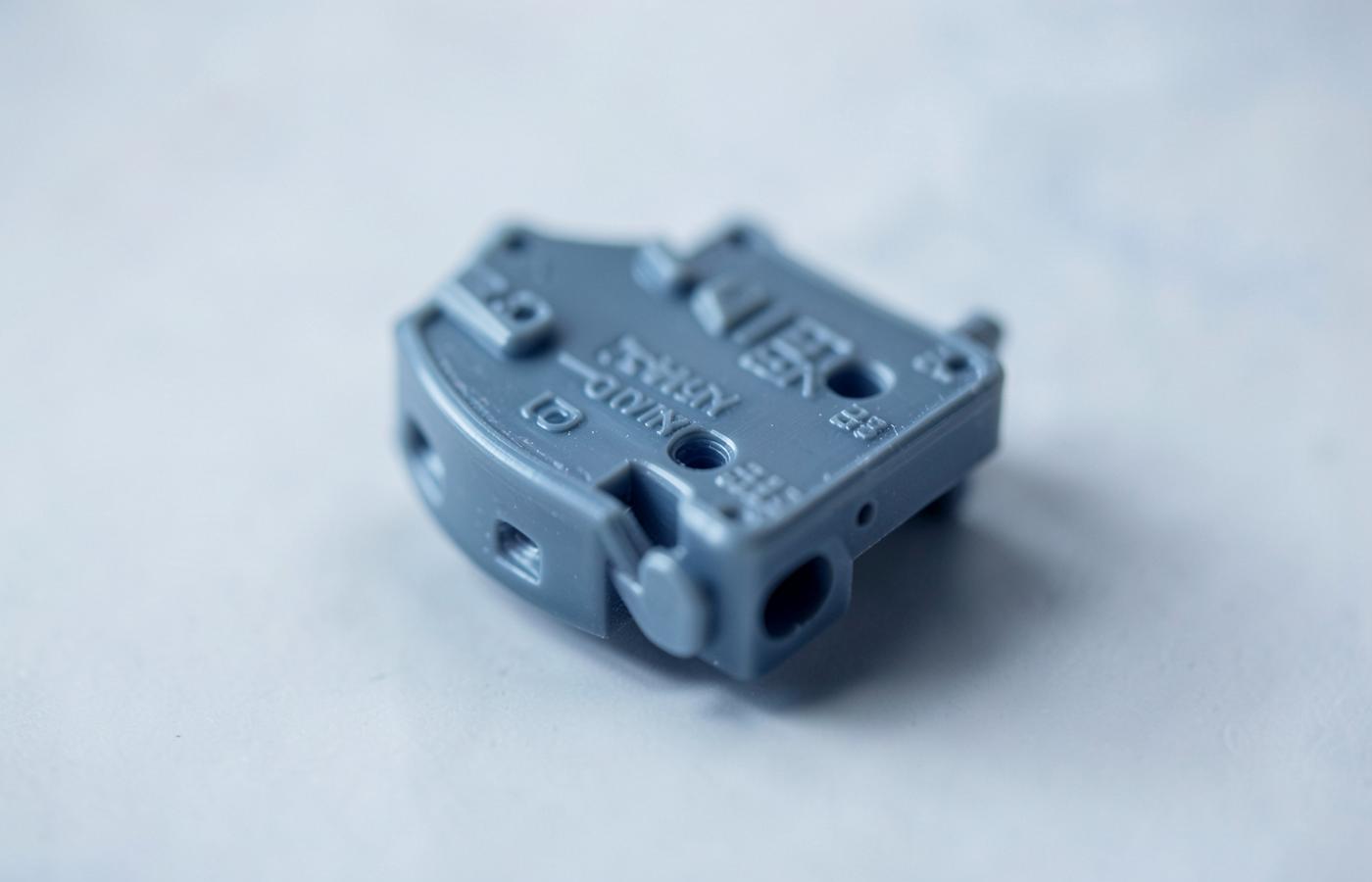 Macro view of a smooth PolyJet printed part with fine embossed detail and no visible layer lines